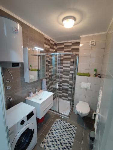 a bathroom with a shower and a sink and a toilet at Skyline by Nights & Smiles in Tuzla