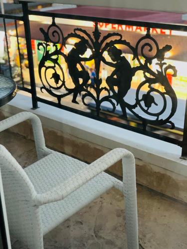 a white chair sitting in front of a window at Hotel AVENUE in Ravda