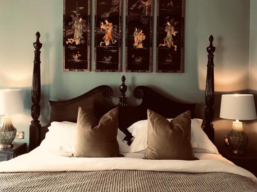 a bedroom with a bed with white sheets and pillows at The Bridge House in Bridport