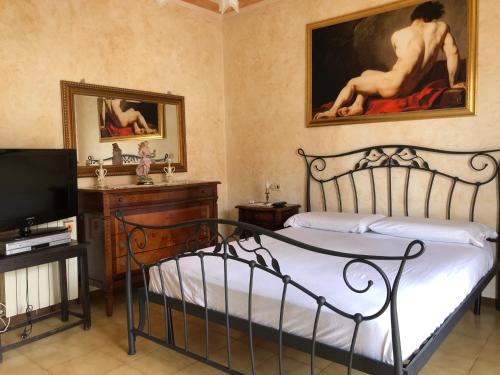 a bedroom with a bed and a painting on the wall at Casa Ceragioli in Viareggio
