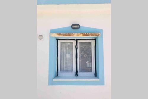 a blue window on the side of a building at Old vineyard in Kinídharos