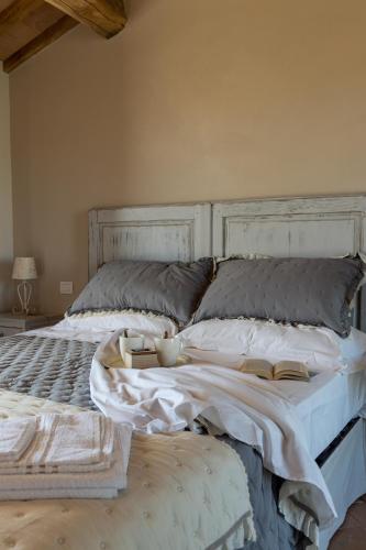 a bedroom with a large bed with a book on it at Agriturismo San Marcello in Castiglione dʼOrcia