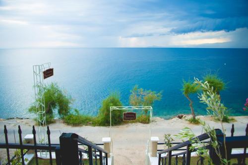 a wedding ceremony on the beach with the ocean at Maistrali Pension in Skala Marion
