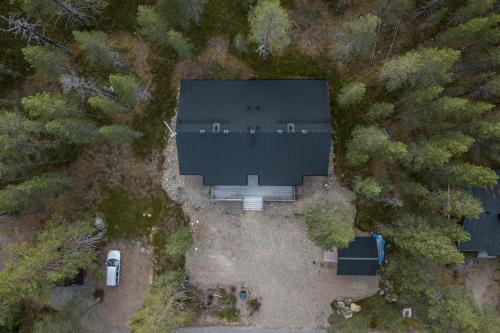 an overhead view of a large building with a car and trees at Hullun Mustikka Levi in Levi