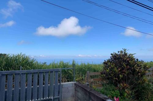 a view of the ocean from a balcony at Maison vue mer chaleureuse et confortable in Petite Île