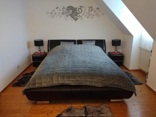 a bedroom with a large bed with two night stands at Jenny's Ferienwohnung in Monschau