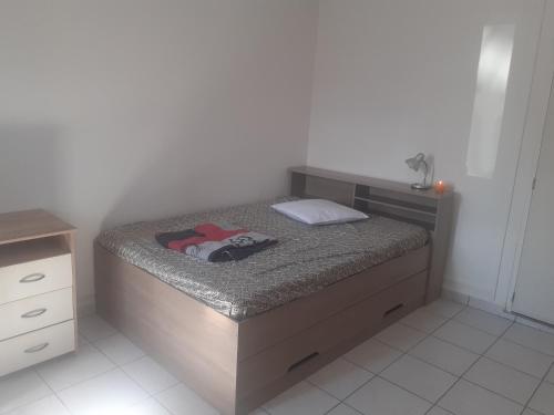 - une petite chambre avec un lit et une commode dans l'établissement Petit Studio KOUROU, à Kourou