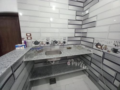 a bathroom with a sink and a counter at Jamaica Guest House in Aswan