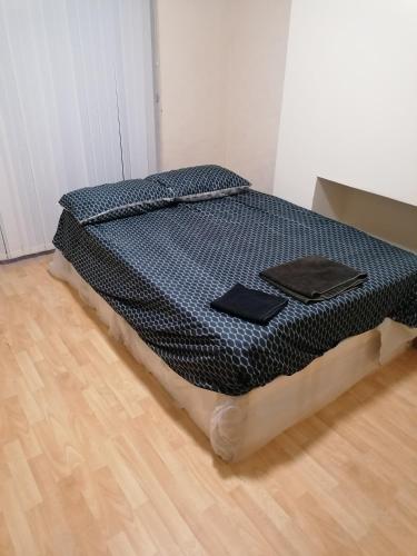 a bed sitting on top of a wooden floor at Vob Property 76 in Hither Green