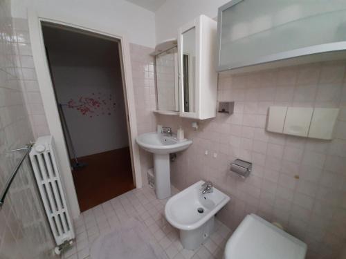 a bathroom with a toilet and a sink at Casa Cavour in Pesaro