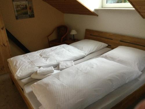 two beds in a bedroom with white sheets and pillows at Ferienhaus und Privatvermietung Andrea Giesecke in Meiningen