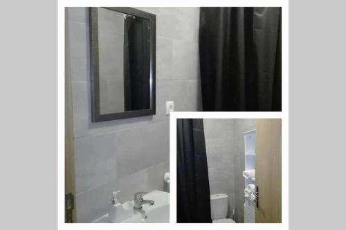 a bathroom with a sink and a toilet and a mirror at SERMAR 1 in Rabo de Peixe