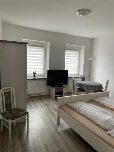a bedroom with two beds and a flat screen tv at Cottbus - zentrumsnah in Cottbus