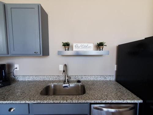 a kitchen with a sink and a counter top at Trendy Midtown Lofts in Cleveland