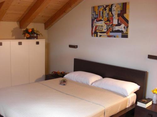 a bedroom with two beds and a painting on the wall at LES BIJOUX Apartments in Pietra Ligure