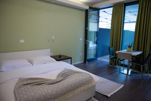 Ένα ή περισσότερα κρεβάτια σε δωμάτιο στο Hana - Apartments