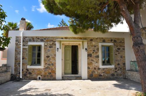 a stone house with a green door at Komfort Stone House in Antimácheia