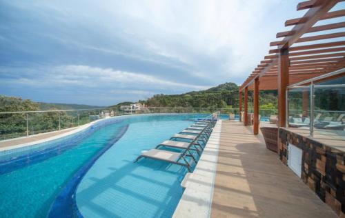 una gran piscina con tumbonas en un edificio en Apartamento - Golden Laghetto Resort Gramado en Gramado