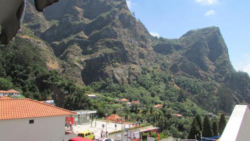 a mountain with a town in front of it at Valley of Nuns Holiday Apartments in Curral das Freiras