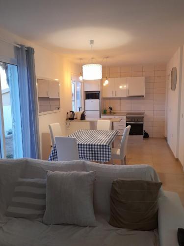 a living room and kitchen with a couch and a table at Casa Azul in Porto Santo