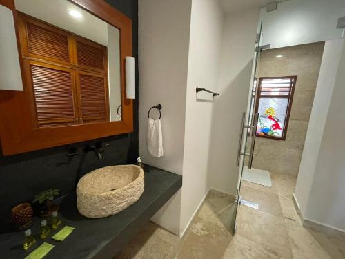 a bathroom with a sink and a shower at Casa Pirata in Holbox Island