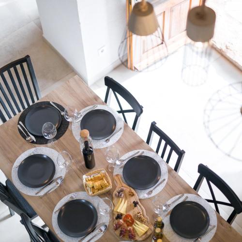 a wooden table with plates of food on it at Villa Humac Hvar in Poljica