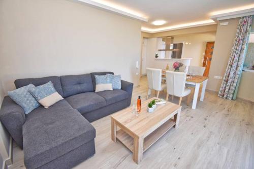 a living room with a couch and a table at Casa Tramonto Beach View Agios Gordios Corfu in Agios Gordios