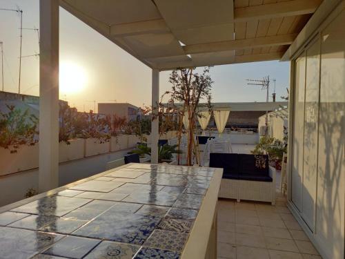 an outdoor patio with a table on a building at B&B LA GRAZIA in Trani