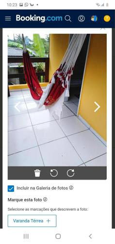 a page of a website with a hammock on the floor at SUITES E CHALES PRIVADOS Rock's&Rose's home in Camburi