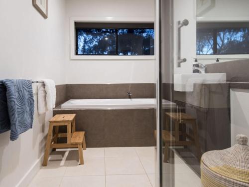 a bathroom with a tub and a sink at Retreat 34A in Daylesford