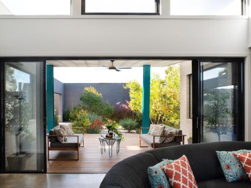 a living room with a large sliding glass door at Arenas South- 3 bedroom, 2 bathroom home in Daylesford