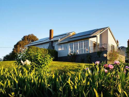 a house with a lot of plants in front of it at Churchills - outstanding views over Daylesford in Daylesford