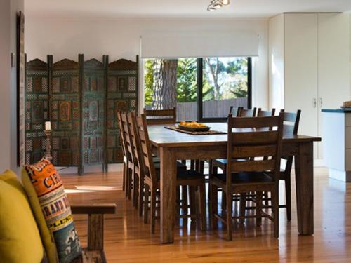 a dining room with a wooden table and chairs at Artemis Retreat in Daylesford