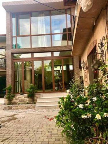 a building with large glass windows and a brick courtyard at Batumi Wonderland in Batumi