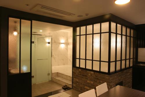 a bathroom with a walk in shower next to a shower at Hotel Banwol Asiad in Incheon
