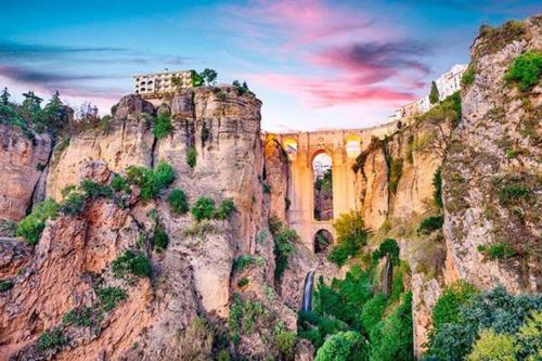 a mountain with a building on top of it at Apartamento Lauria centro in Ronda