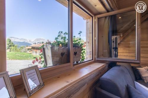 a room with a couch and a large window at Le Granit in Combloux