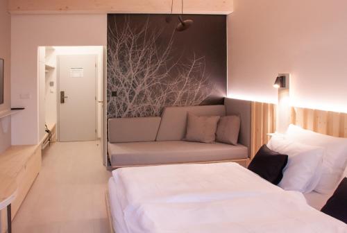 a hotel room with a bed and a couch at Prezidentská in Bedřichov