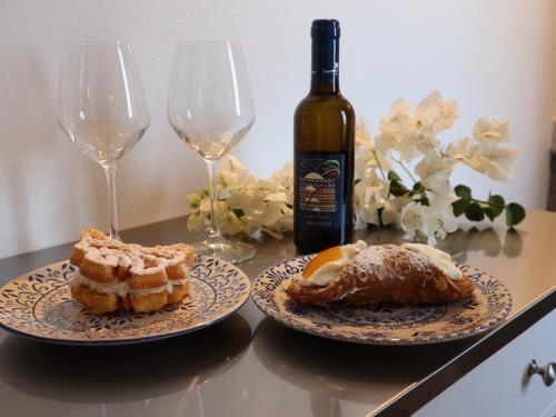 two plates of food and two wine glasses on a table at Antura in Pantelleria