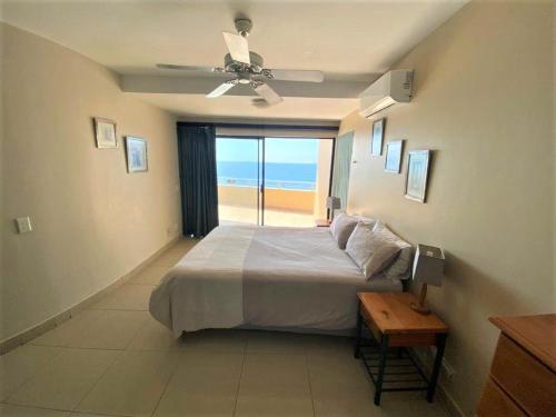 a bedroom with a bed and a view of the ocean at Lazy Lizard 51 in Umdloti