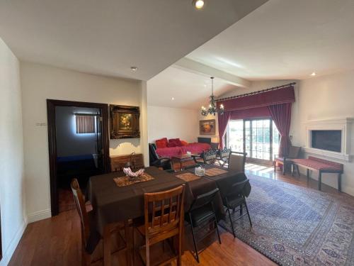 a dining room and living room with a table and chairs at Entire Second Flr - Santa Monica Luxury Roman Villa in Los Angeles