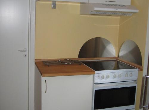 a small kitchen with a stove and a sink at Engbjerg BnB in Hirtshals