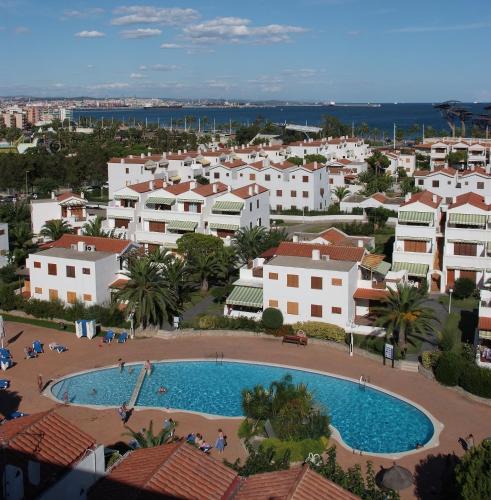 an aerial view of a town with a swimming pool at Apartamentos Estival Park in La Pineda