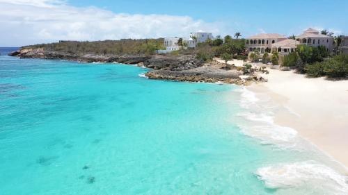 an aerial view of a beach with houses and the ocean at Sandcastle Villa & Beach House in The Valley