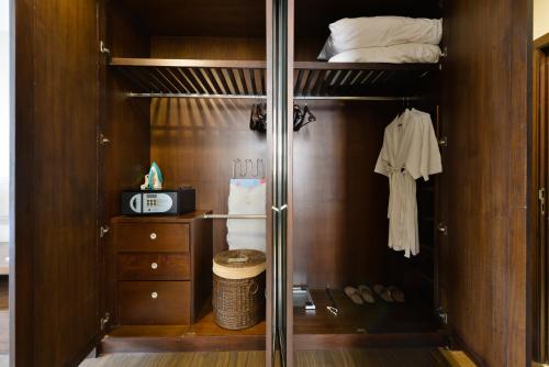 a walk in closet with a glass door at Grand Asoke Suites Boutique Residence in Bangkok
