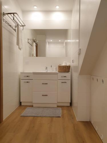 a bathroom with a sink and a mirror at Apartament Podmiejska Stargard in Stargard