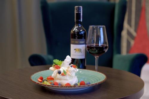 a plate of ice cream and a glass of wine at QUEST HOTEL - dawniej Hotel Planeta in Brzesko