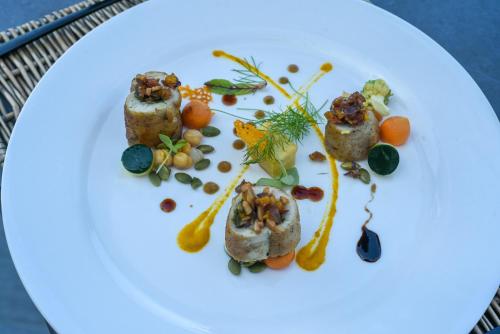 a plate of food on a white plate at Villa Bluu Zanzibar in Jambiani