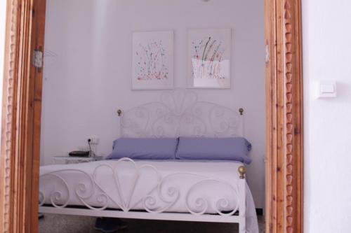 a bedroom with a white bed in a mirror at Casa Marina in Colònia de Sant Jordi