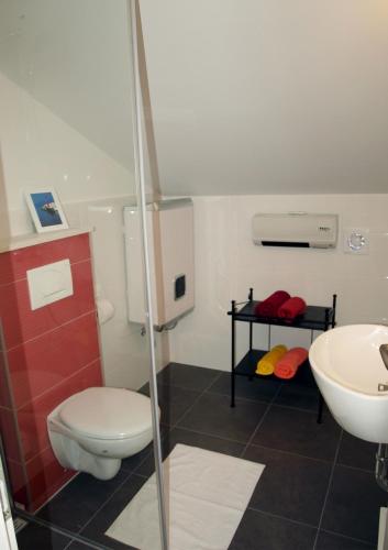 a bathroom with a toilet and a sink at Apartments Issa in Makarska